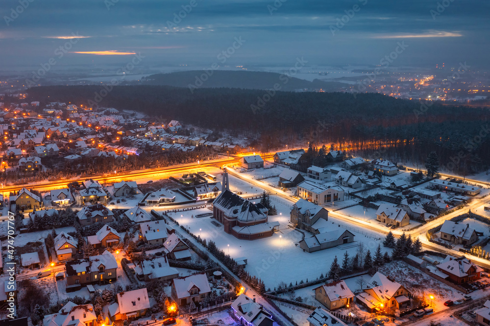 Aerial landscape of small village at dusk covered with fresh snow