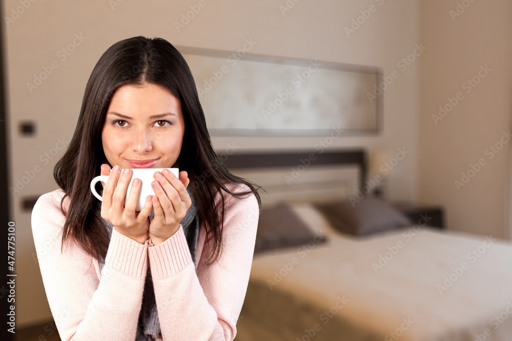 Photo of pretty dreamy young woman sitting couch drinking coffee indoors house home room