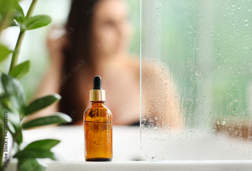 Bottle of essential oil in bathroom