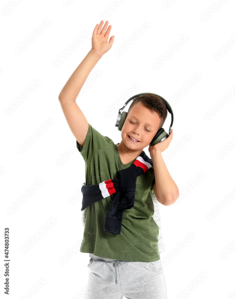 Dancing little boy listening to music, isolated on white