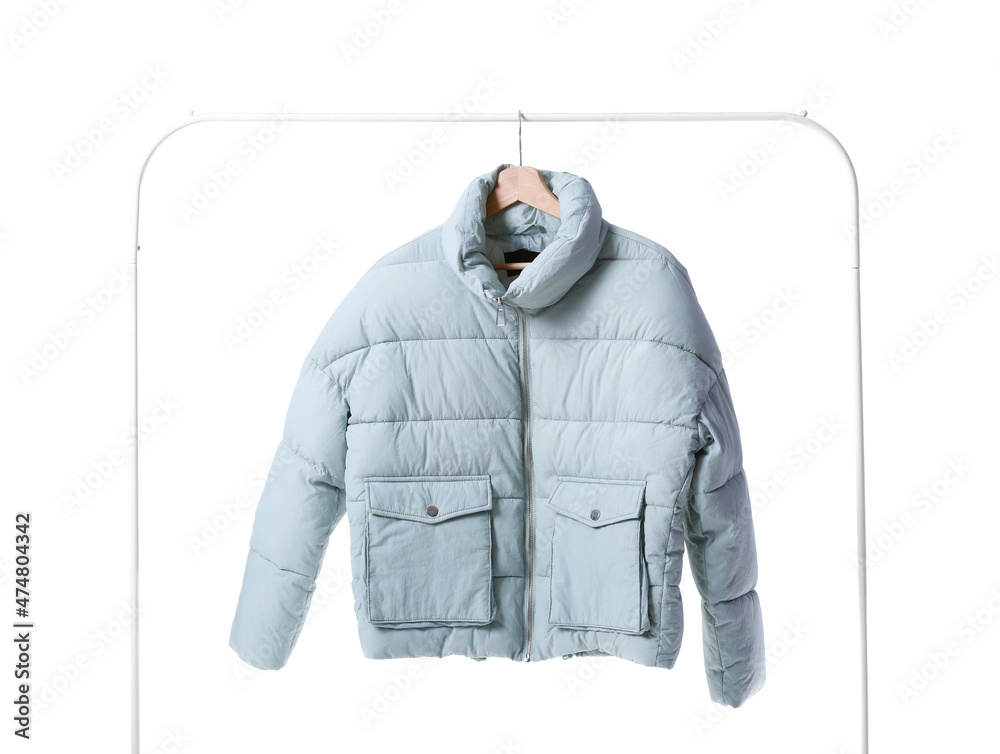 Rack with modern down jacket on white background