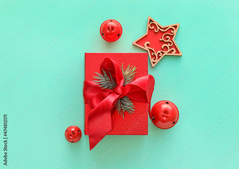 Composition with Christmas gift box, balls and fir branches on color background