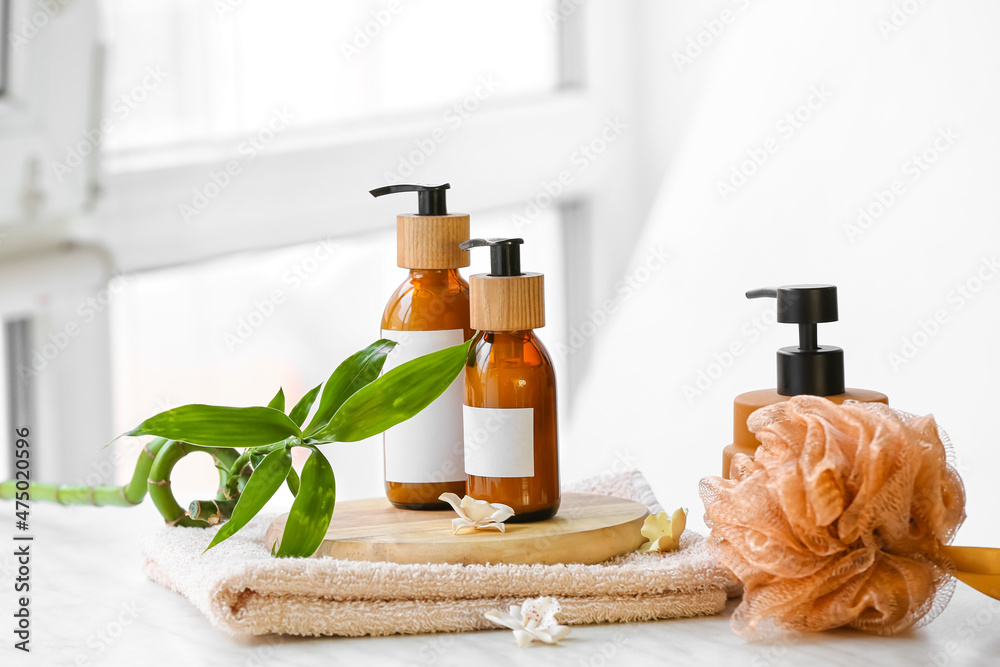 Spa set with bottles of cosmetics on table