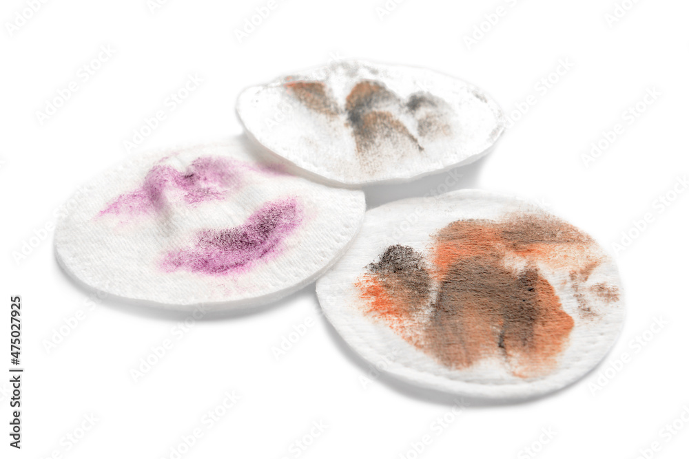 Dirty cotton pads after removing makeup on white background