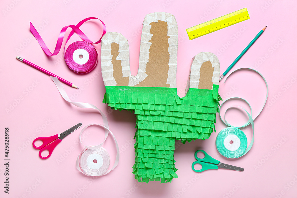 Preparation of Mexican pinata on color background