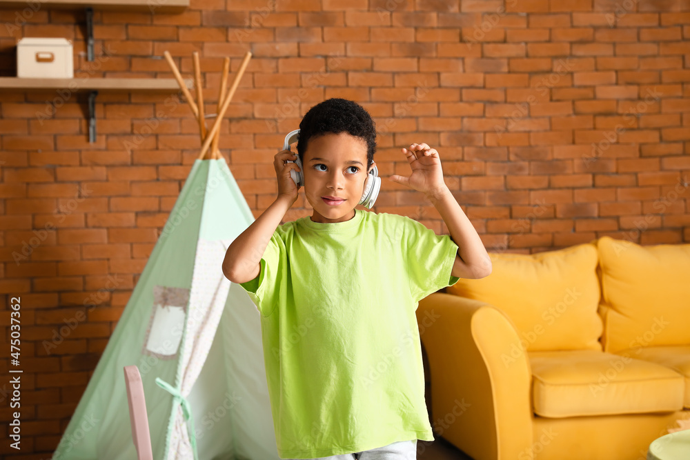 Dancing African-American boy listening to music at home