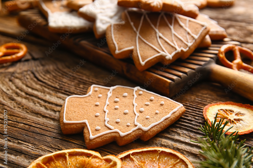 Delicious gingerbread cookies on wooden background, closeup