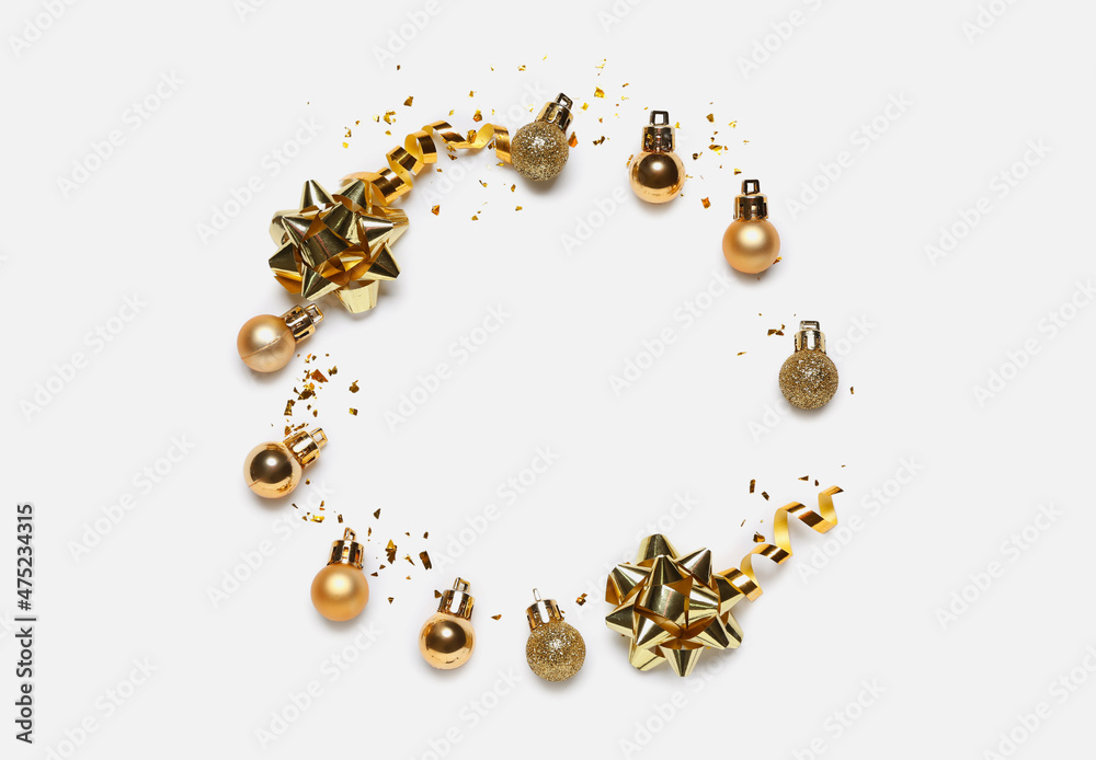 Frame made of golden Christmas decorations and confetti on white background