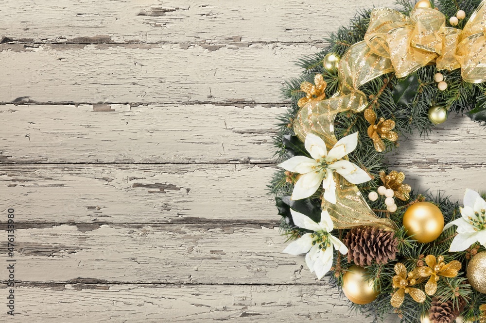 Christmas wreath with decorations on a wooden background