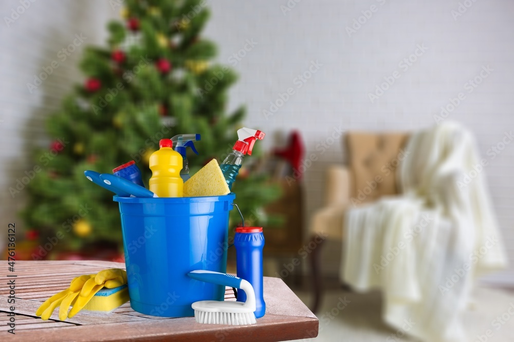 Cleaning before Christmas. Multicolored cleaning supplies. Sponges, rags and spray with festive deco