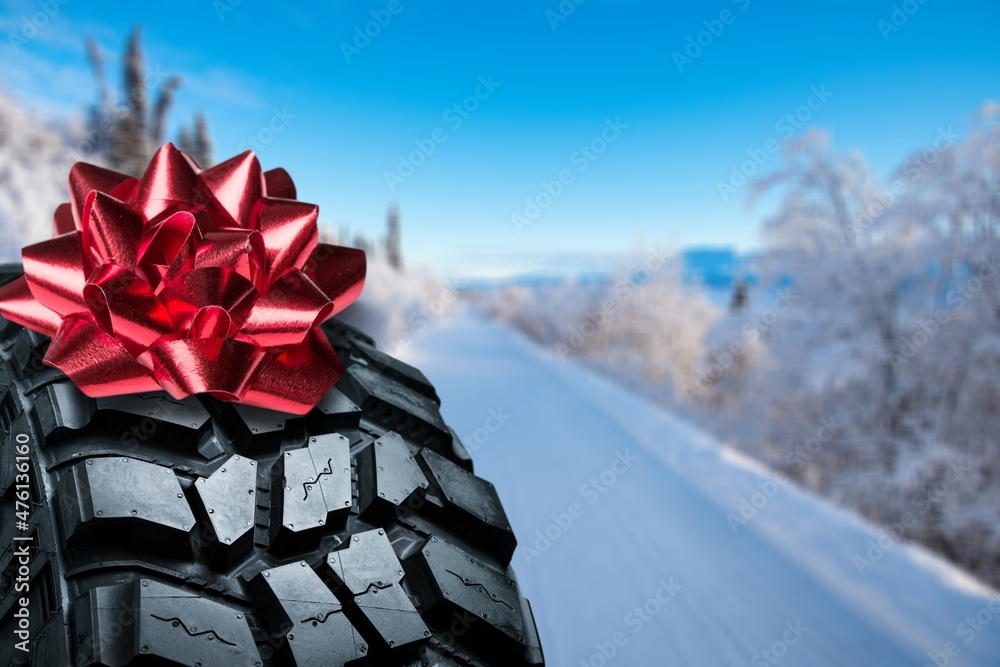 Classic black rubber tire, on the backgrounds in a bow for christmas