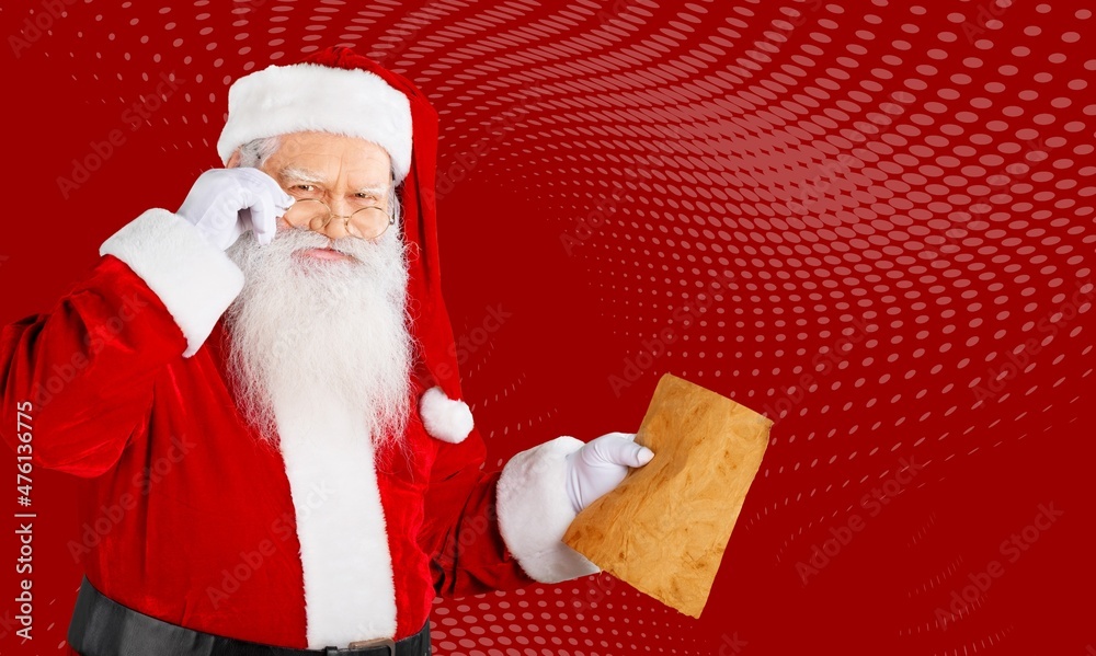 Portrait of amazed fat white-haired Santa holding in hands reading wish present gift list