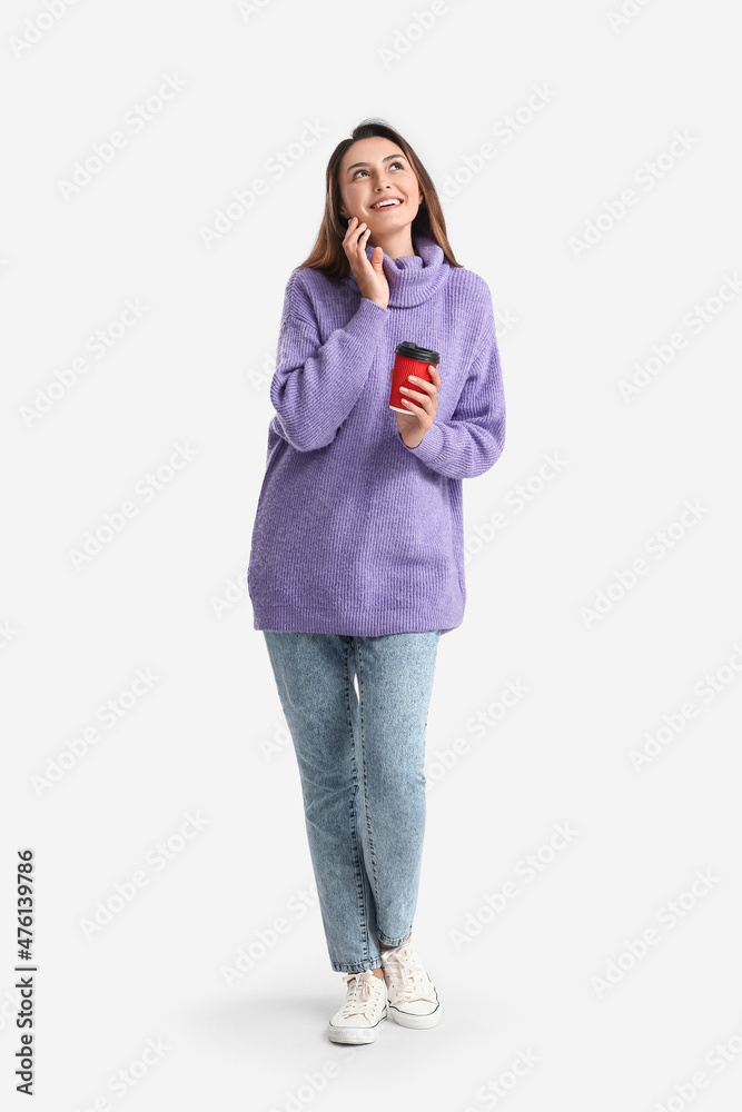 Beautiful woman with cup of coffee on white background