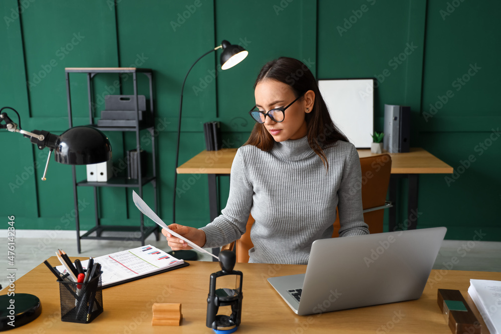 Female notary public working in office