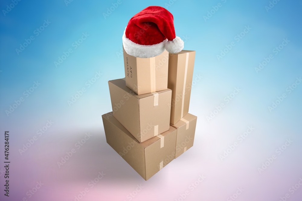 Stack or heap of brown carton cardboard boxes with red Santa hat, Christmas shopping or online order