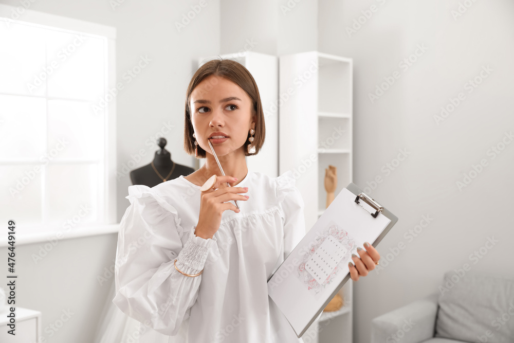 Female wedding planner with Save the Date Announcement in office