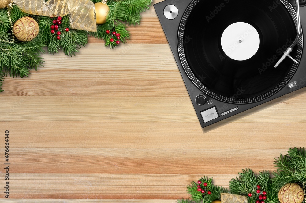 Record player and Christmas decor on desk background