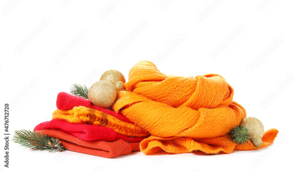 Winter hats, scarf and Christmas decor on white background