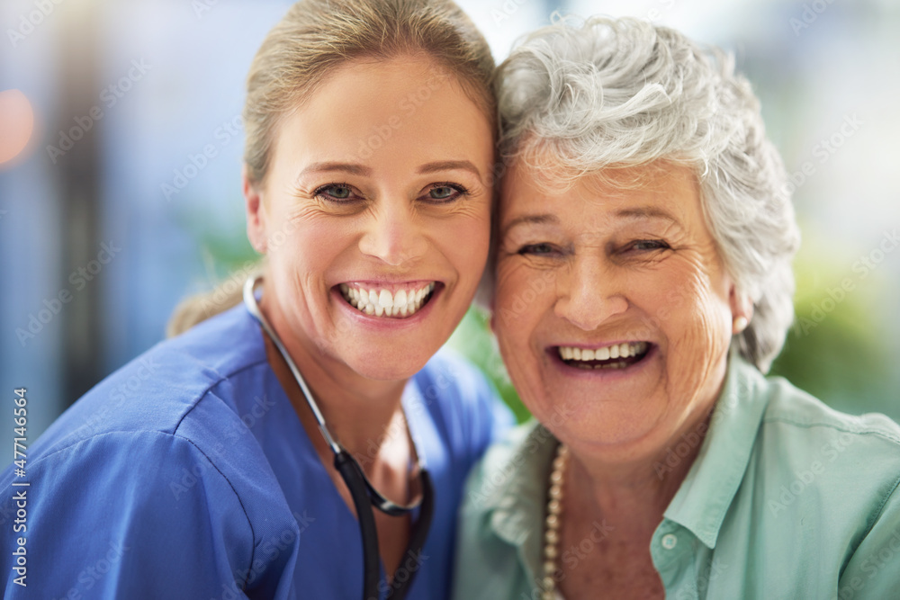 Portrait of a smiling nurse with her senior patient in a hospital