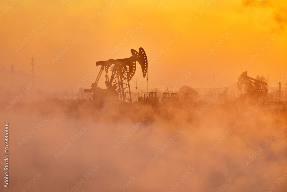 The pumping units in lakeside sunrise, Daqing oil fields Heilongjiang province, China.