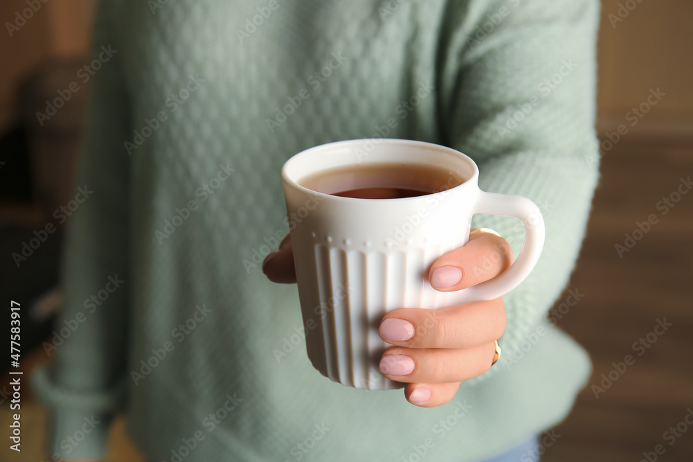 女人在室内喝着美味的茶，特写镜头