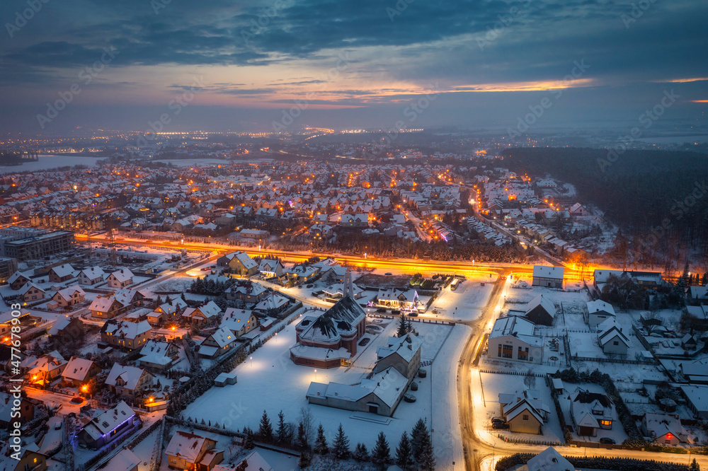 Aerial landscape of small village at dusk covered with fresh snow