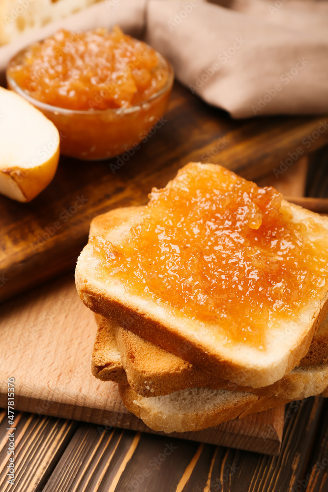 Bread with tasty pear jam on table, closeup