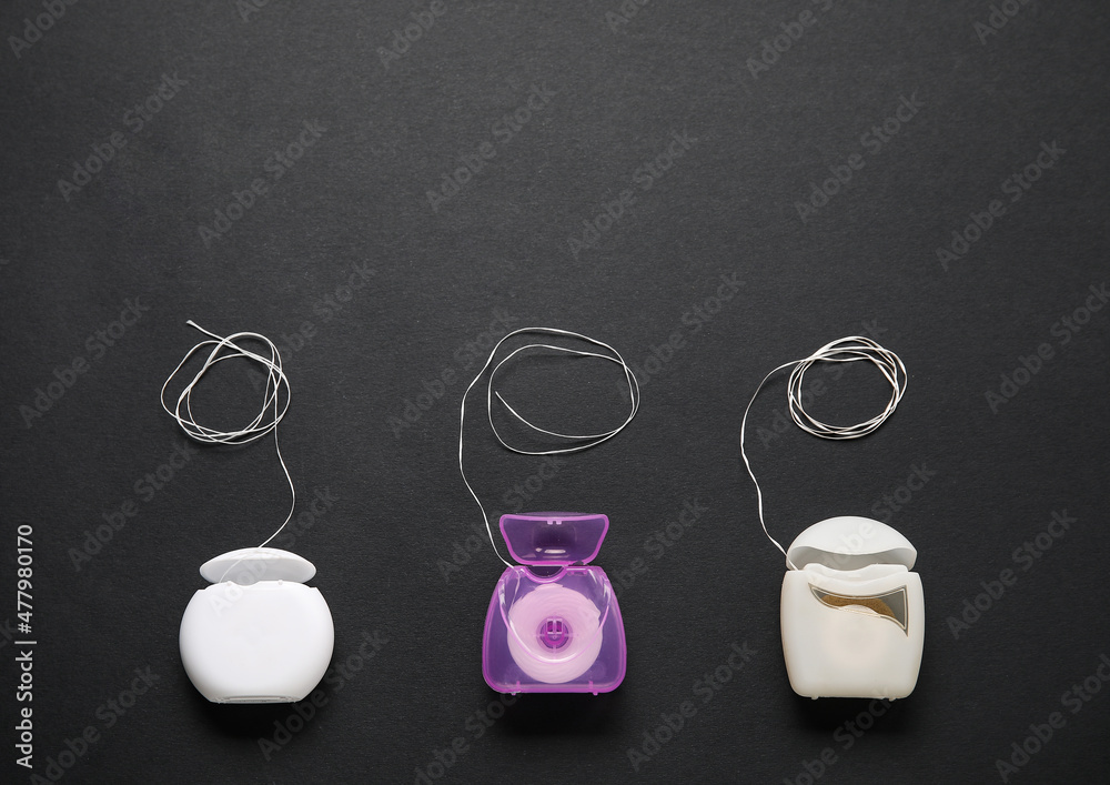 Different dental floss on black background