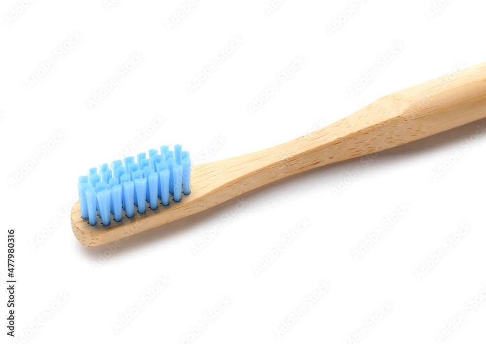 Blue bamboo toothbrush on white background, closeup