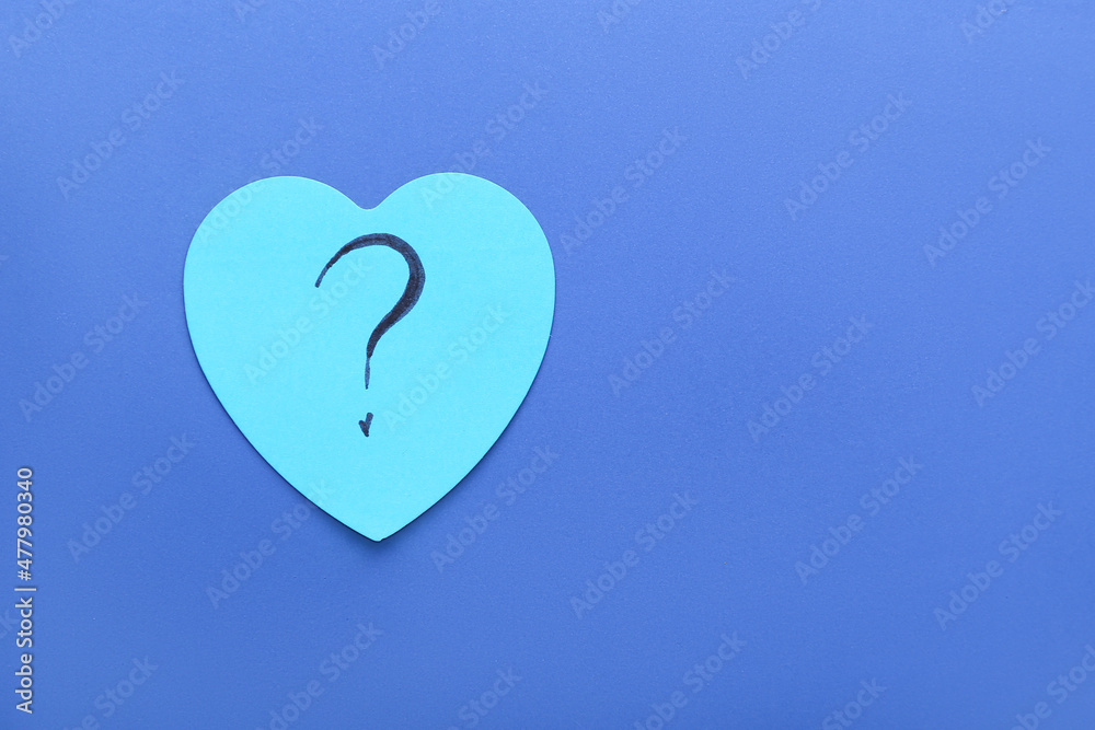 Heart shaped sticky note with question mark on blue background