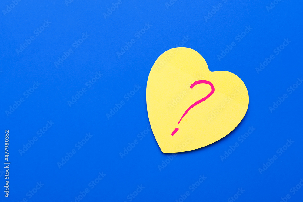 Heart shaped sticky note with question mark on blue background