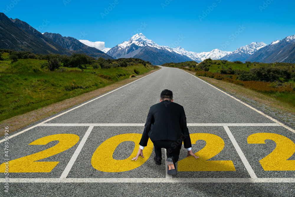 The 2022 New Year journey and future vision concept . Businessman traveling on highway road leading 