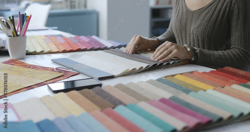 Woman selecting fabric swatches hands close up