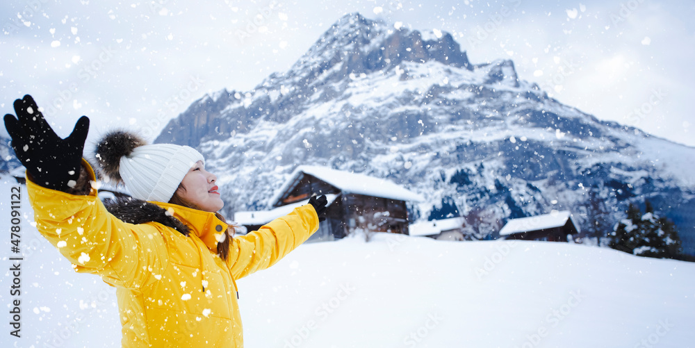 Grindelwald Switzerland top of Europe, Asian woman wearing yellow coat.She is feel Very happy on vac