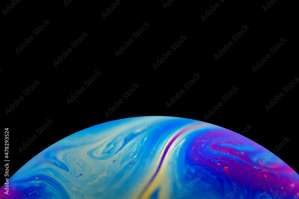 Soap bobble close-up. Multicolor psychedelic alien planet with an atmosphere in the darkness of the 