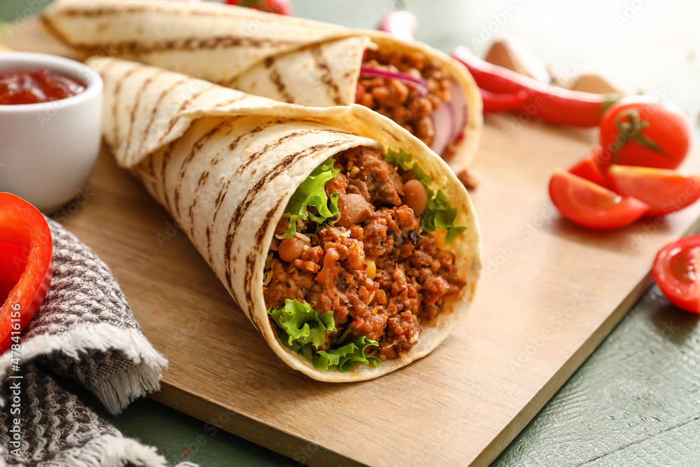 Tasty burrito on table, closeup