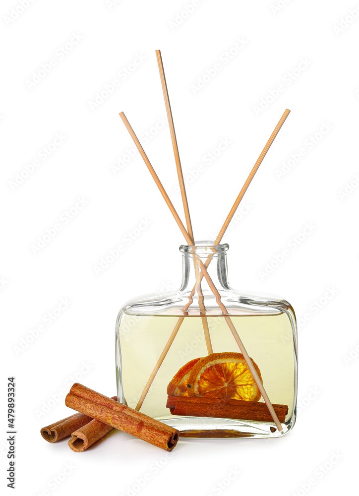 Air freshener with cinnamon and orange fruit isolated on white