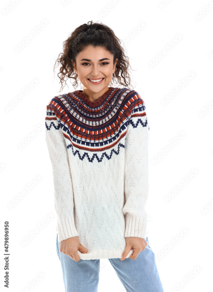 Pretty young woman in warm sweater on white background