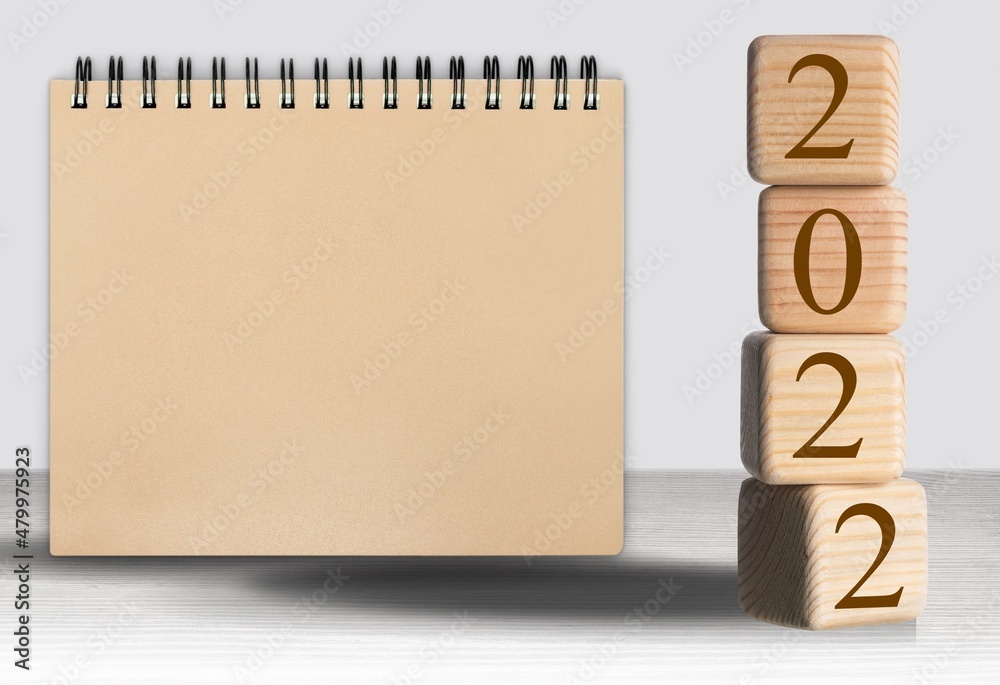 2022 concept with cubes on wooden table background, mockup calendar