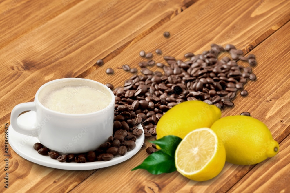 Lemon black coffee in cup, coffee beans, lemon slices