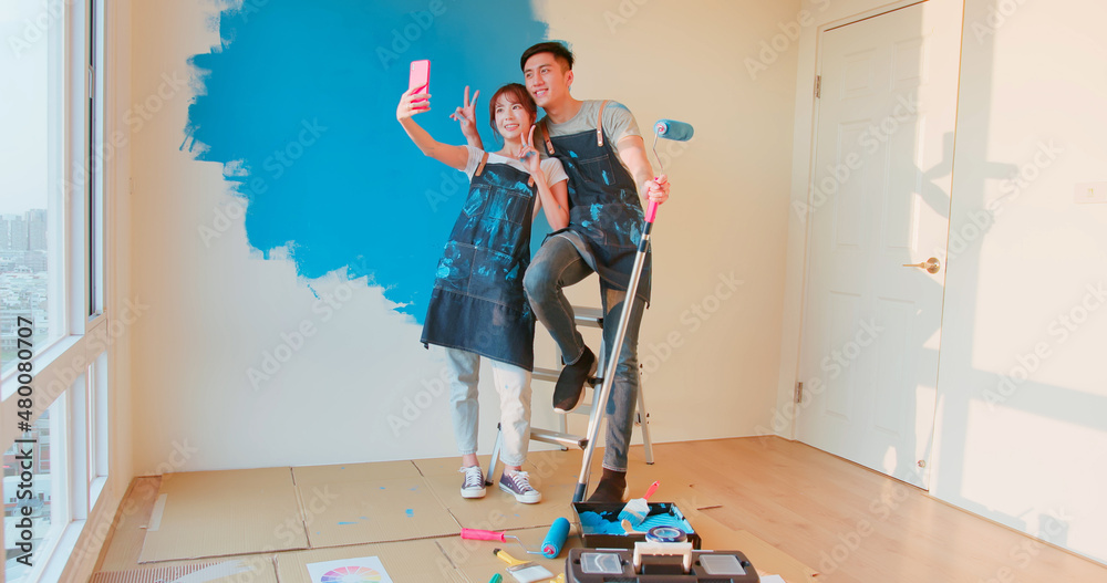 couple painting wall