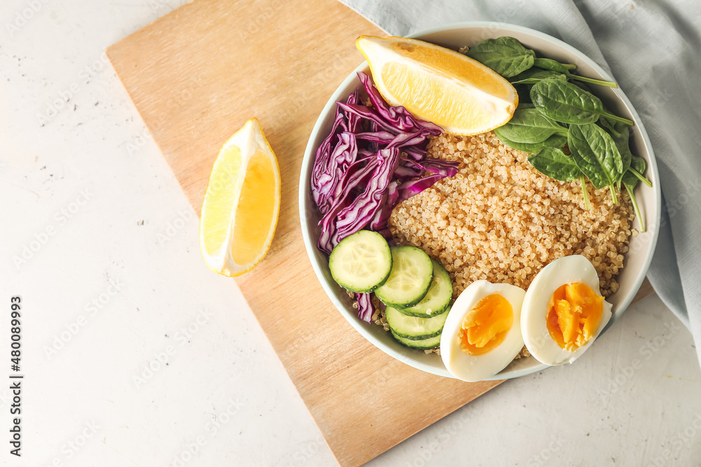 Healthy quinoa bowl with egg on light table