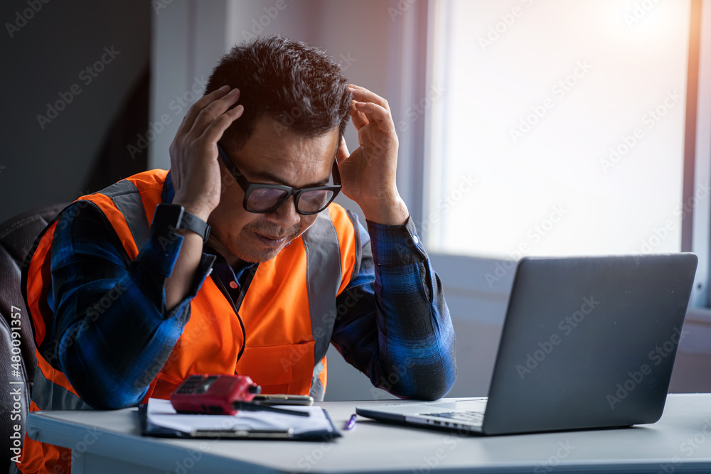 Stress engineer holding hands at his head at construction site,He is having problems in work.