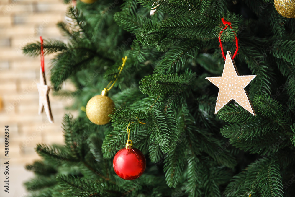 Star made of cardboard hanging on Christmas tree, closeup