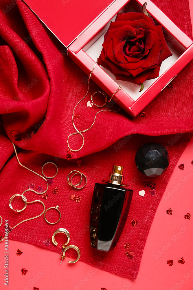 Perfume and accessories for Valentines day on red background