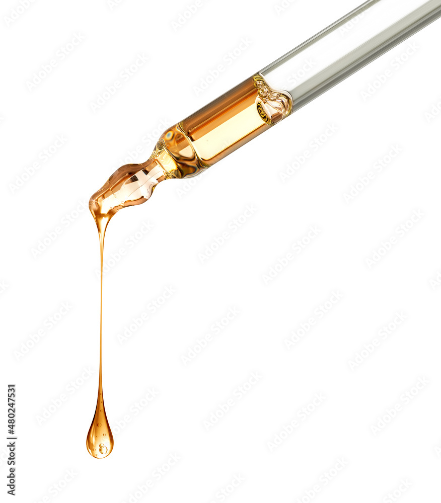 Stretched oily drop falls from a pipette close-up isolated on a white background