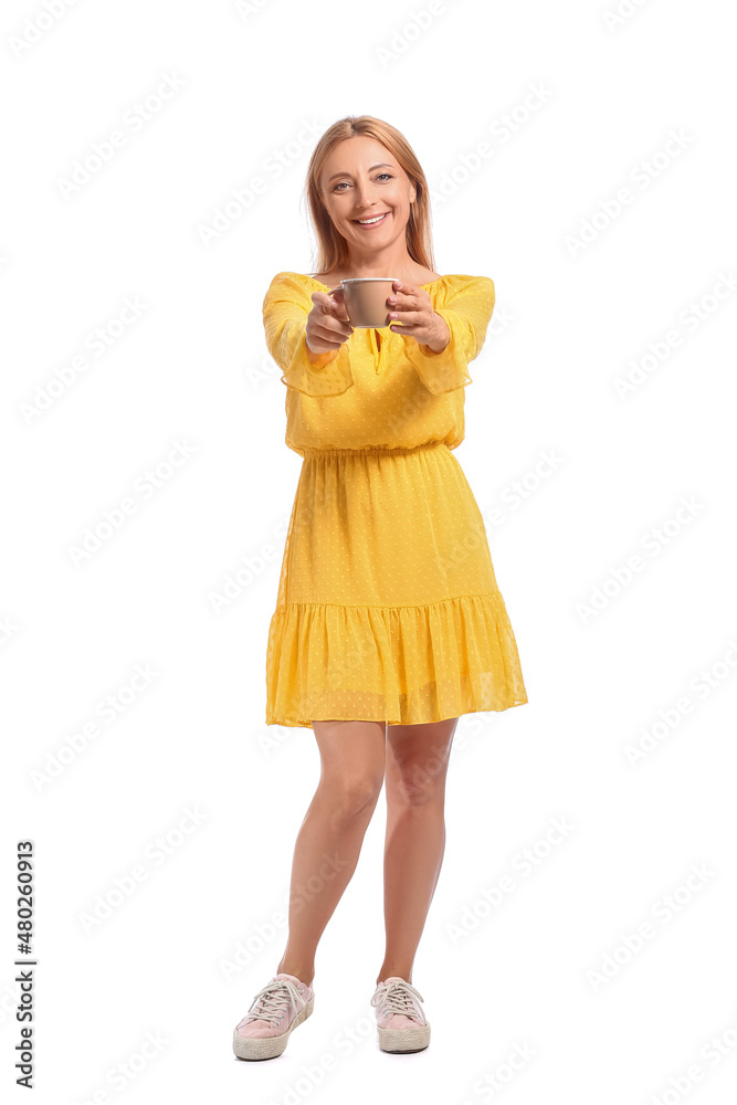 Beautiful mature woman with cup of coffee on white background