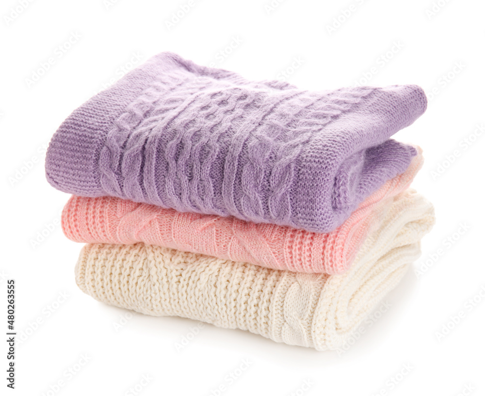 Stylish baby sweaters on white background