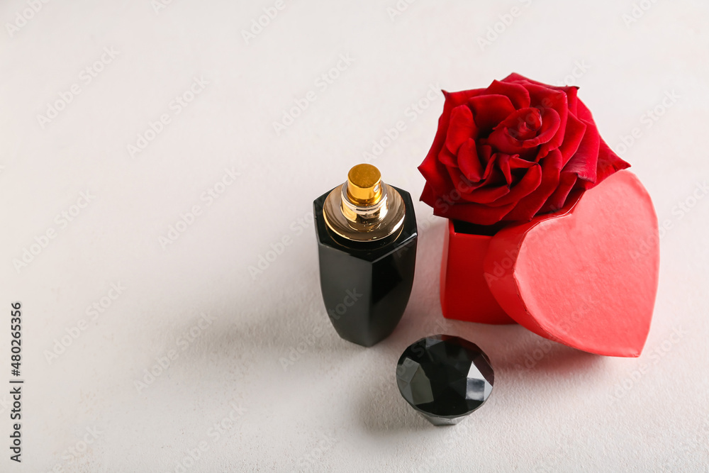 Perfume and rose for Valentines day on light background