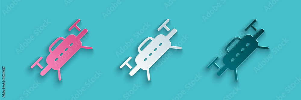 Paper cut Drone flying icon isolated on blue background. Quadrocopter with video and photo camera sy